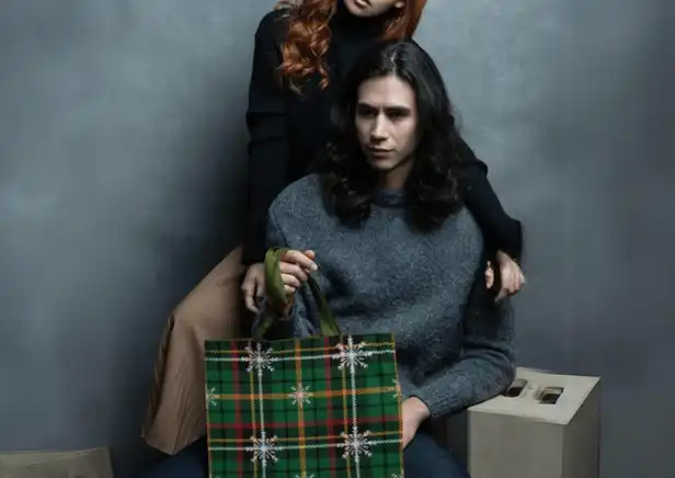 Couple holding the Winter Whispers Plaid Tote Bag - A touch of sophistication in a classic plaid design for every occasion.